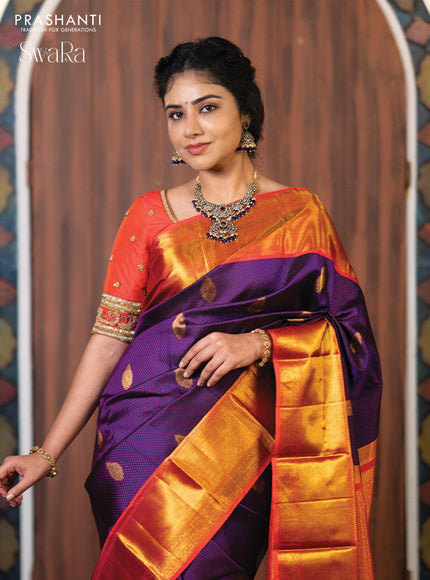 Pure kanjivaram silk saree dark blue and dual shade of pinkish orange with allover self emboss & zari buttas and rich zari woven border