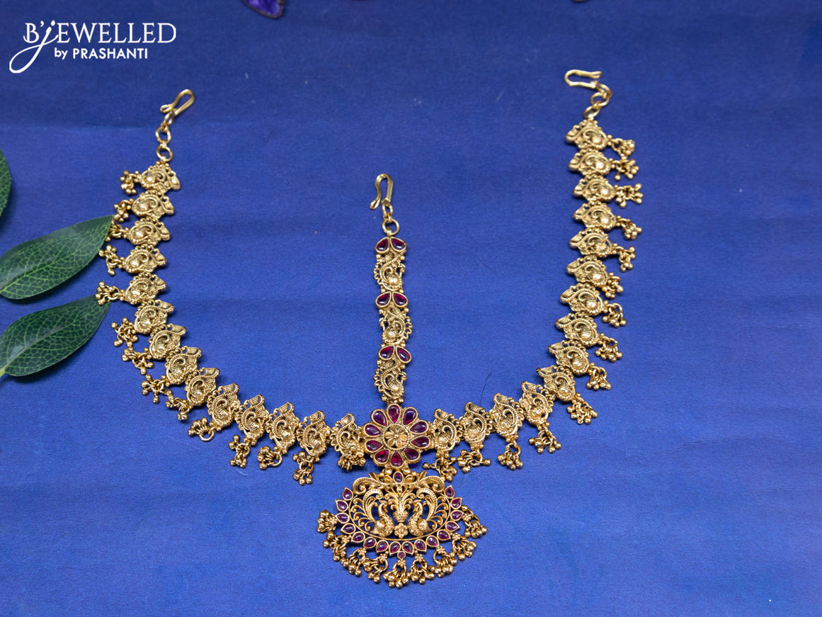 Antique maang tikka peacock design with pink kemp stones and golden beads hangings