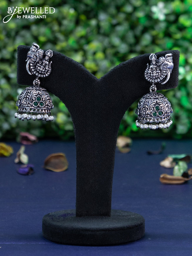 Oxidised jhumka lakshmi design with emerald stones and pearl hangings