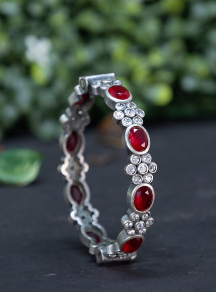 Oxidised screw type bangle with maroon and cz stones