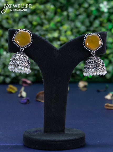 Oxidised jhumka with mustard yellow stone and pearl hangings