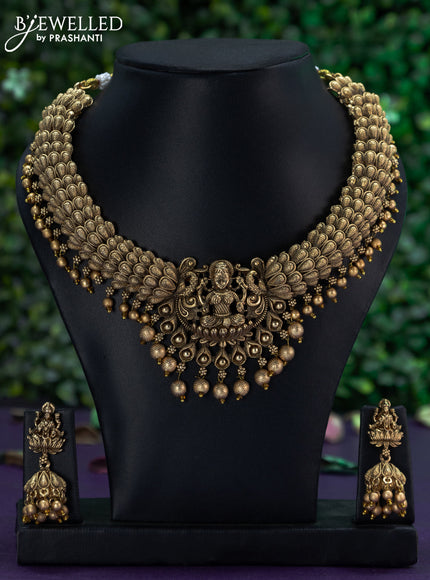 Antique necklace with lakshmi pendant and golden beads hangings