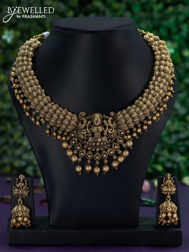 Antique necklace with lakshmi pendant and golden beads hangings