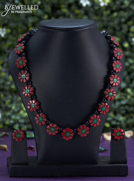 Terracotta red necklace with floral design