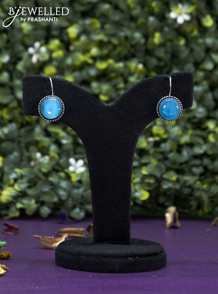 Oxidised hanging type earring with light blue stones