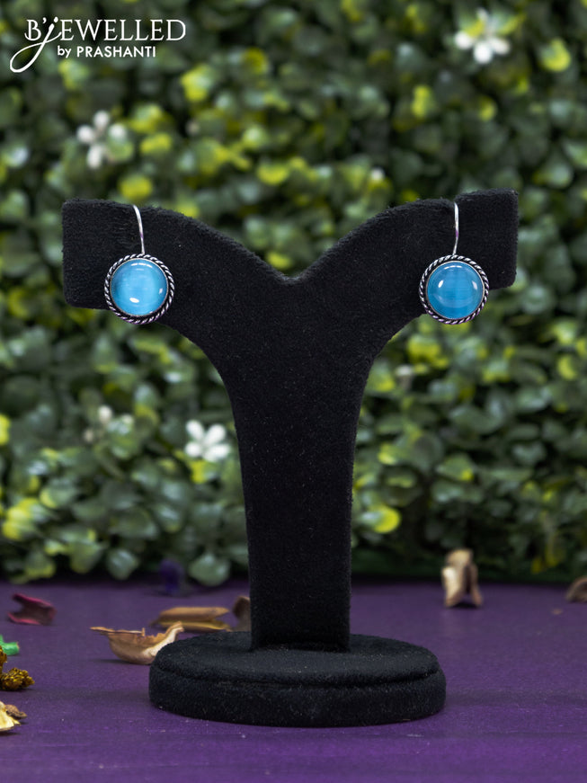 Oxidised hanging type earring with ice blue stones