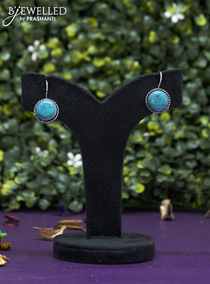 Oxidised hanging type earring with light blue stones