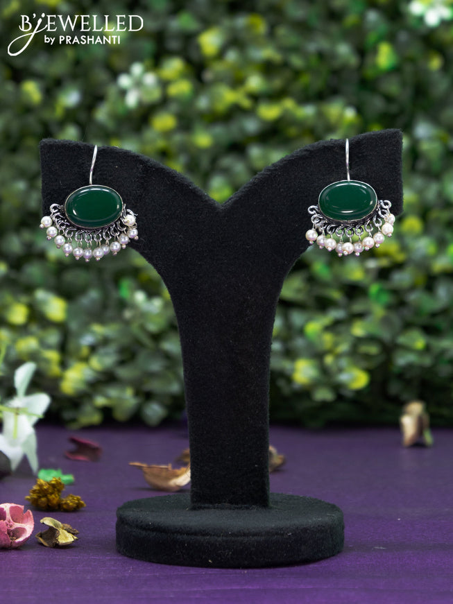 Oxidised hanging type earring with emerald stones and pearl hanging