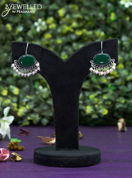 Oxidised hanging type earring with emerald stones and pearl hanging