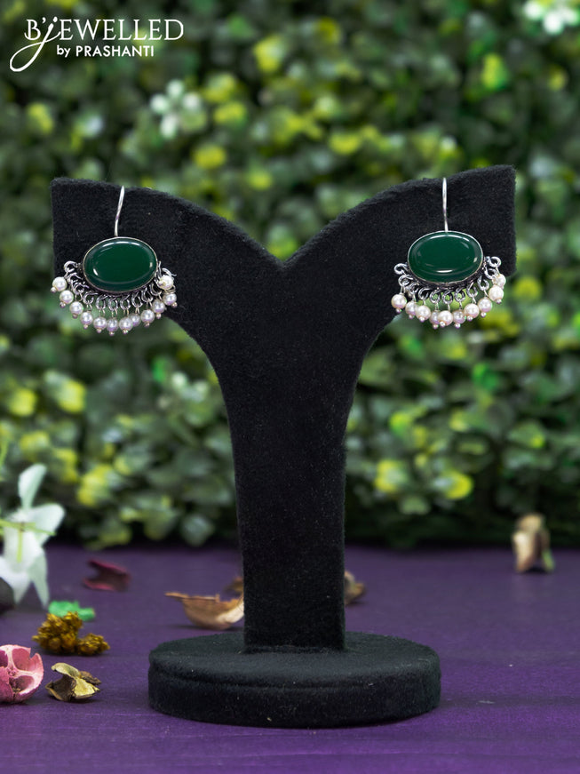 Oxidised hanging type earring with emerald stones and pearl hanging