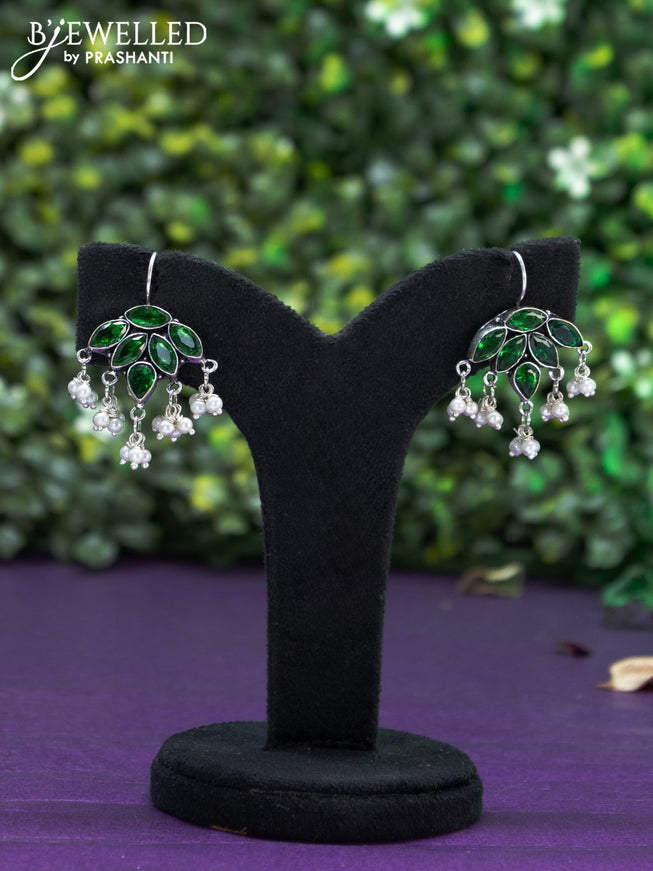 Oxidised hanging type earring with emerald stones and pearl hanhing