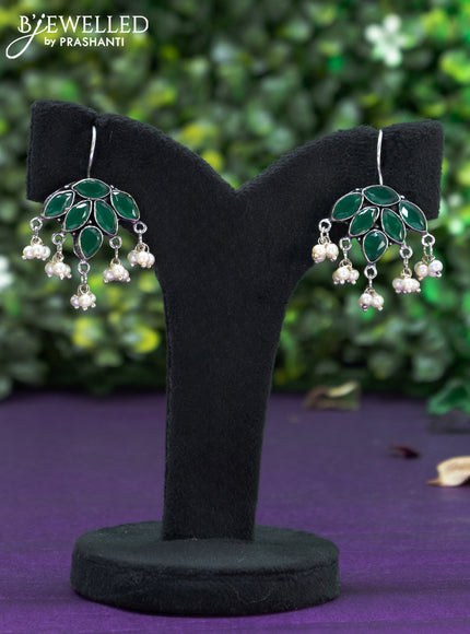 Oxidised hanging type earring with emerald stones and pearl hanhing