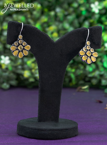 Oxidised hanging type earring with yellow stones