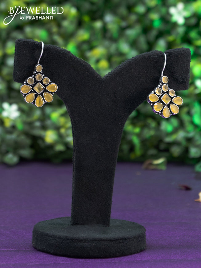 Oxidised hanging type earring with yellow stones