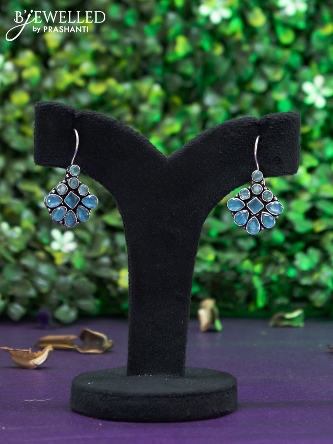 Oxidised hanging type earring with mint green and ice blue stones