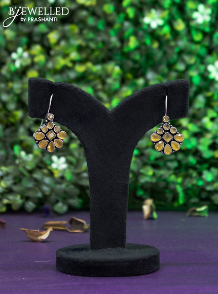 Oxidised hanging type earring with yellow stones