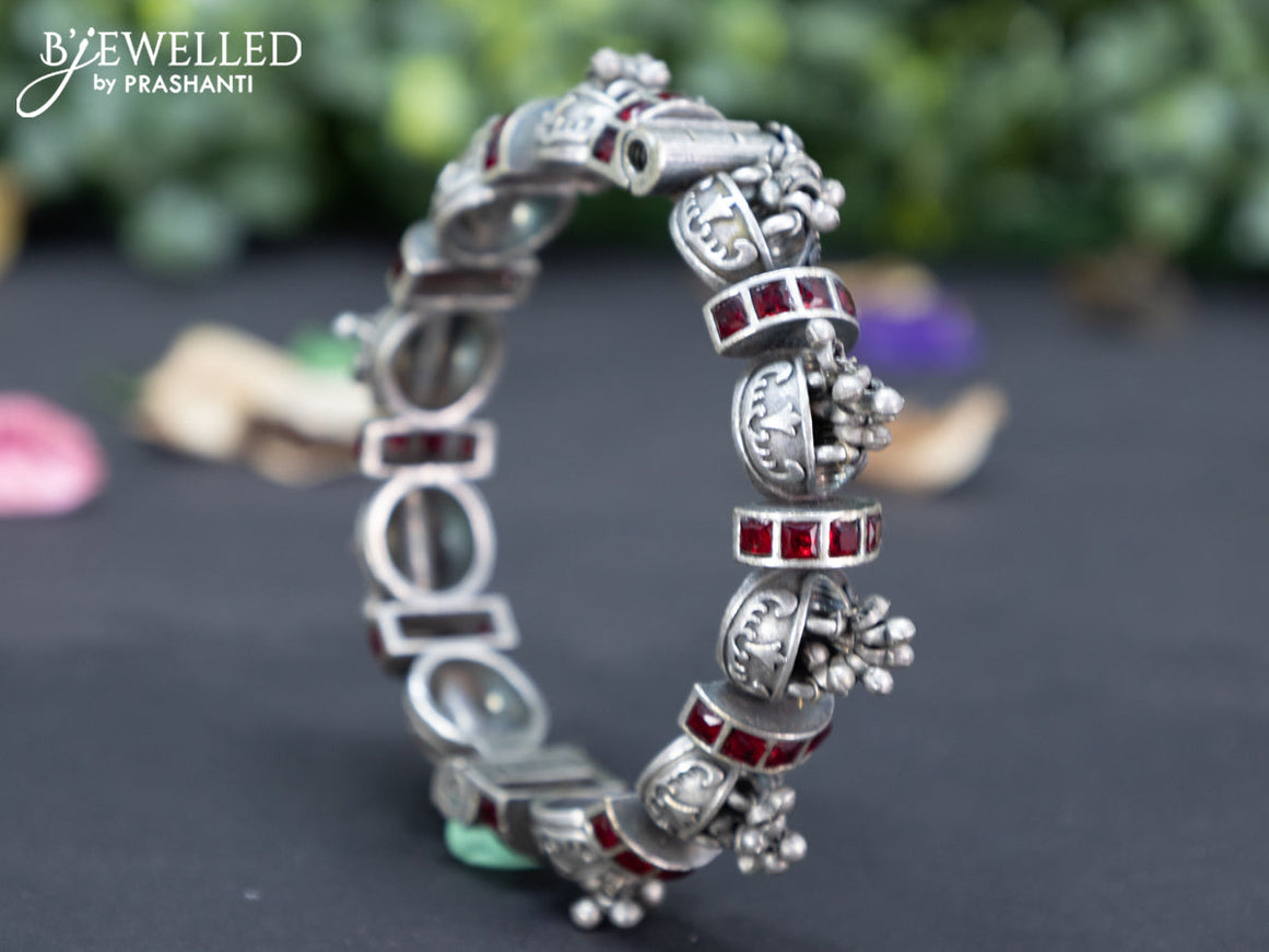 Oxidised screw type bangle with maroon stones and hanging