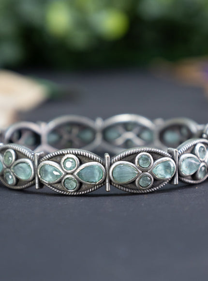 Oxidised screw type bangle with mint green stones