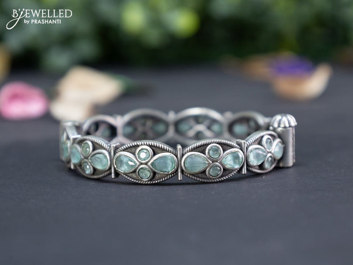 Oxidised screw type bangle with mint green stones