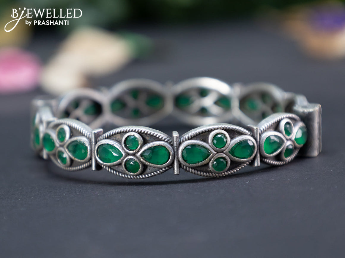 Oxidised screw type bangle with emerald stones