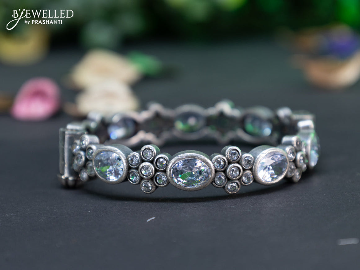 Oxidised floral design screw type bangle with cz stones