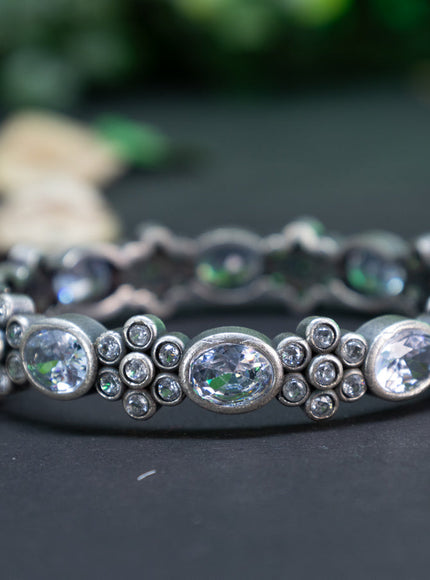 Oxidised floral design screw type bangle with cz stones