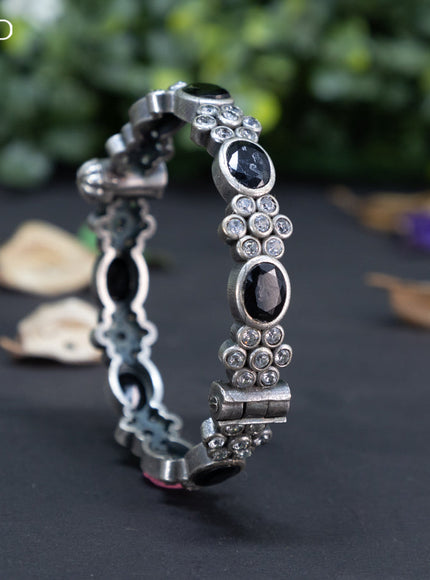 Oxidised floral design screw type bangle with black and cz stones