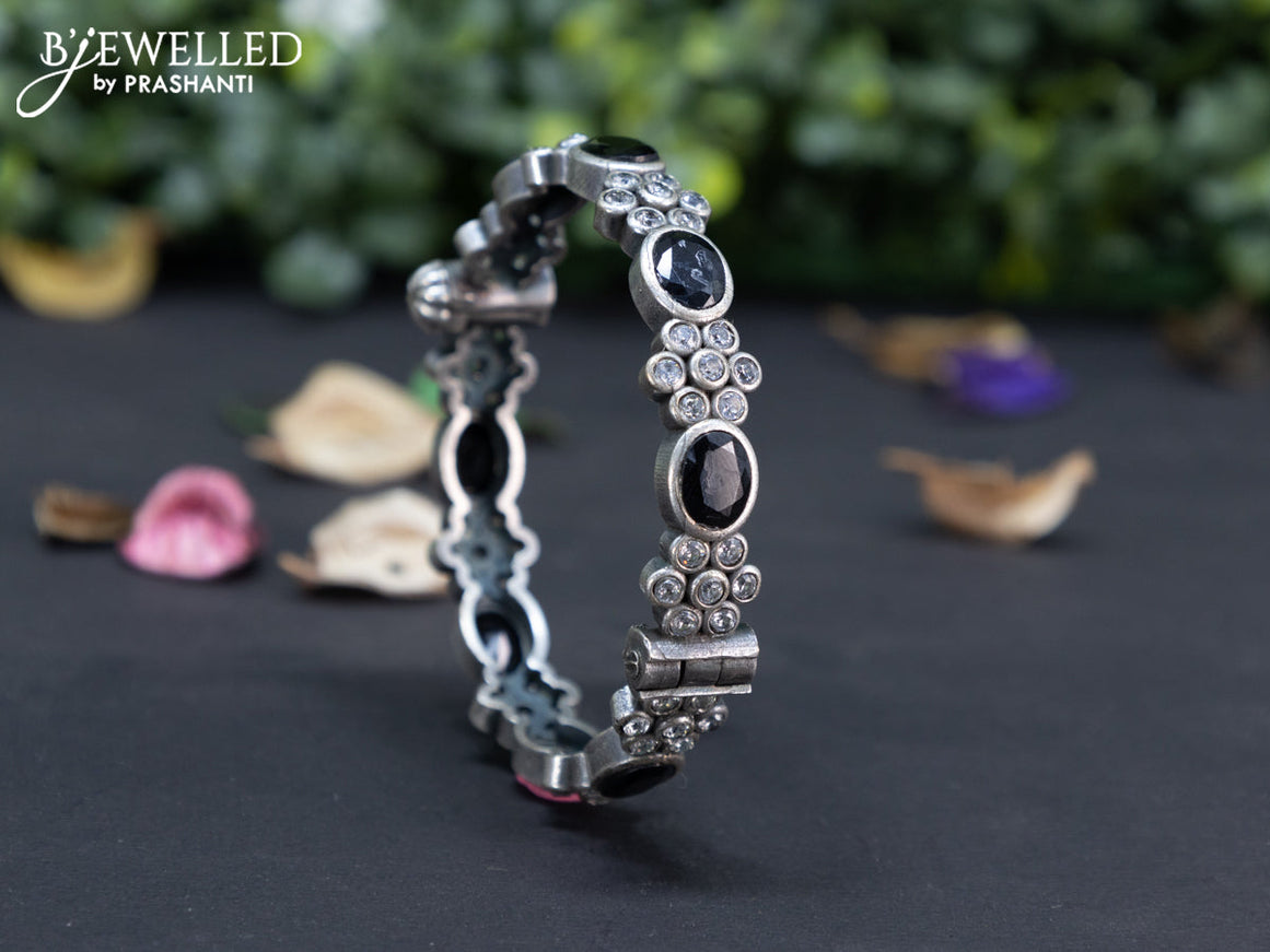 Oxidised floral design screw type bangle with black and cz stones