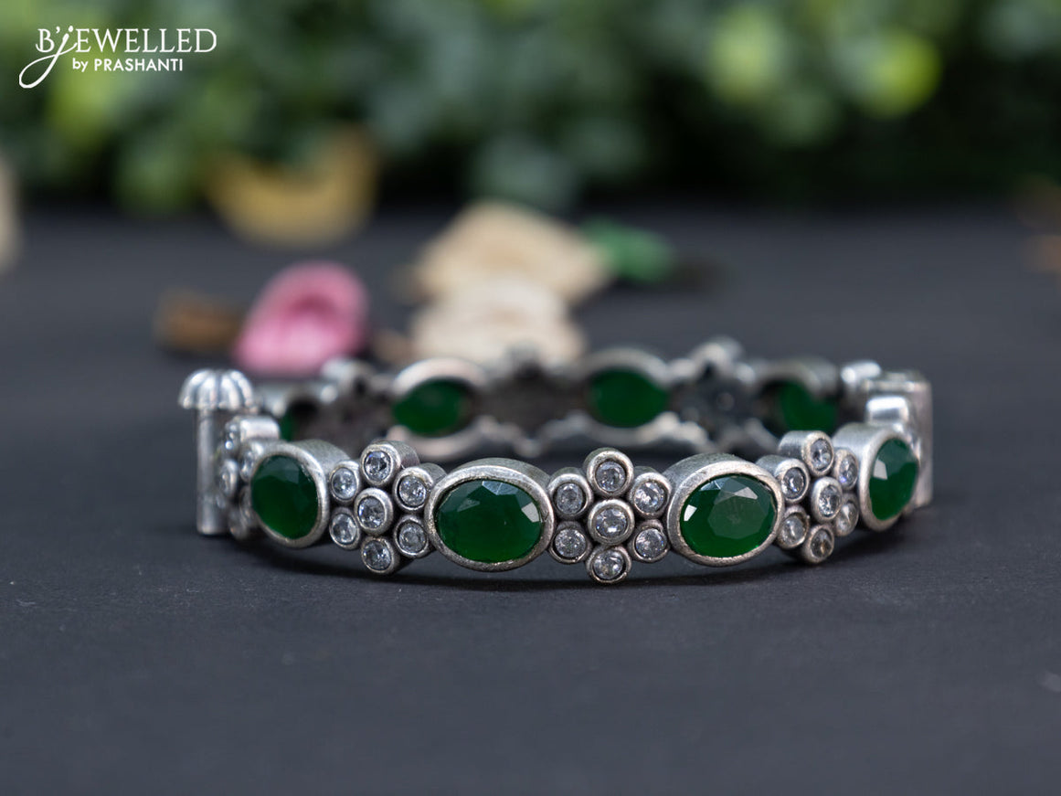 Oxidised floral design screw type bangle with emerald and cz stones