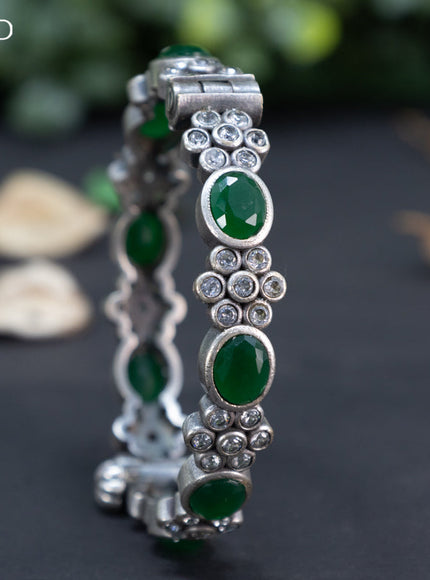 Oxidised floral design screw type bangle with emerald and cz stones