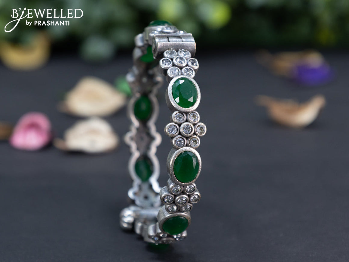 Oxidised floral design screw type bangle with emerald and cz stones