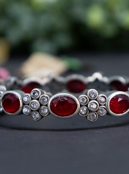 Oxidised floral design screw type bangle with ruby and cz stones