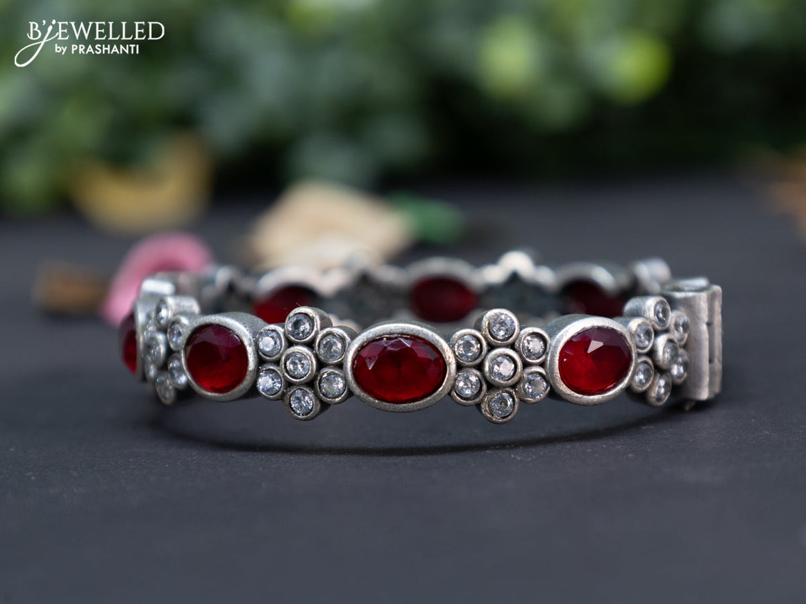 Oxidised floral design screw type bangle with ruby and cz stones