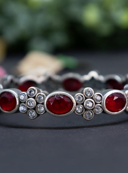 Oxidised floral design screw type bangle with ruby and cz stones