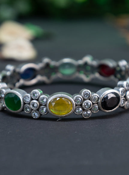 Oxidised floral design screw type bangle with multi colour stones