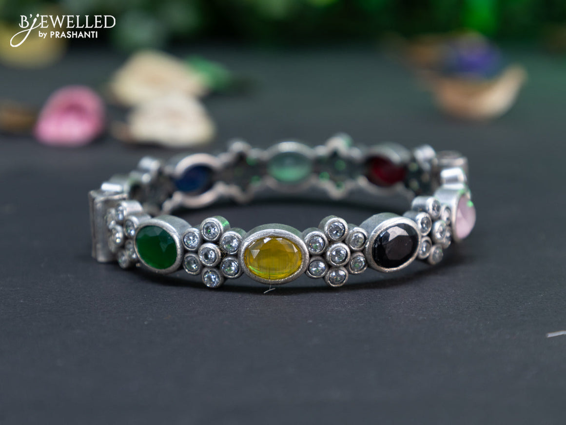 Oxidised floral design screw type bangle with multi colour stones