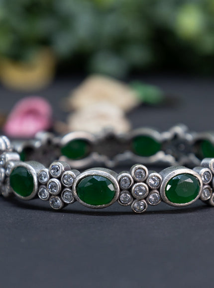 Oxidised floral design screw type bangle with emerald and cz stones