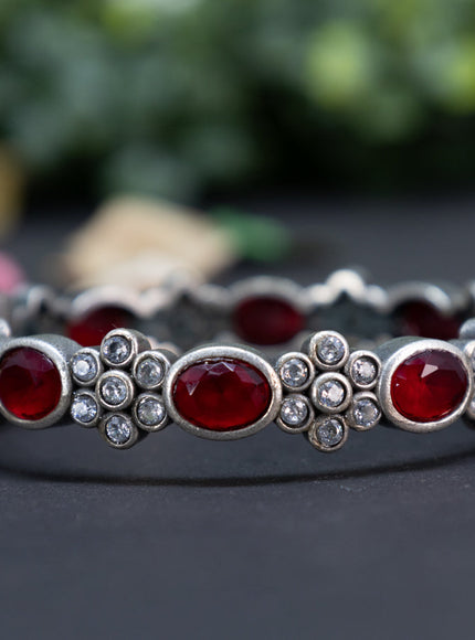 Oxidised floral design screw type bangle with ruby and cz stones