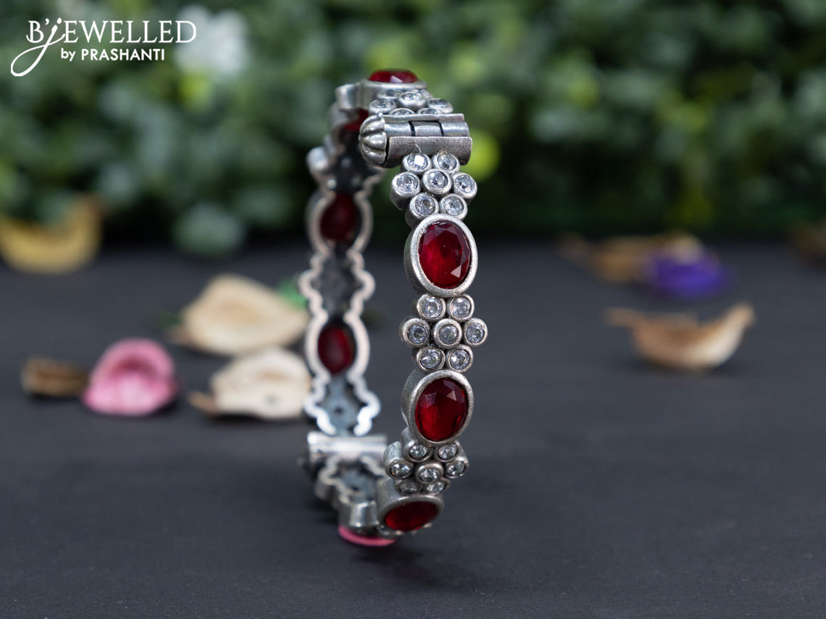 Oxidised floral design screw type bangle with ruby and cz stones