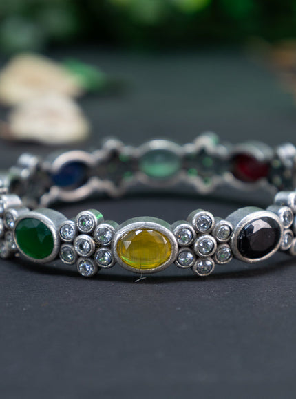 Oxidised floral design screw type bangle with multi colour stones