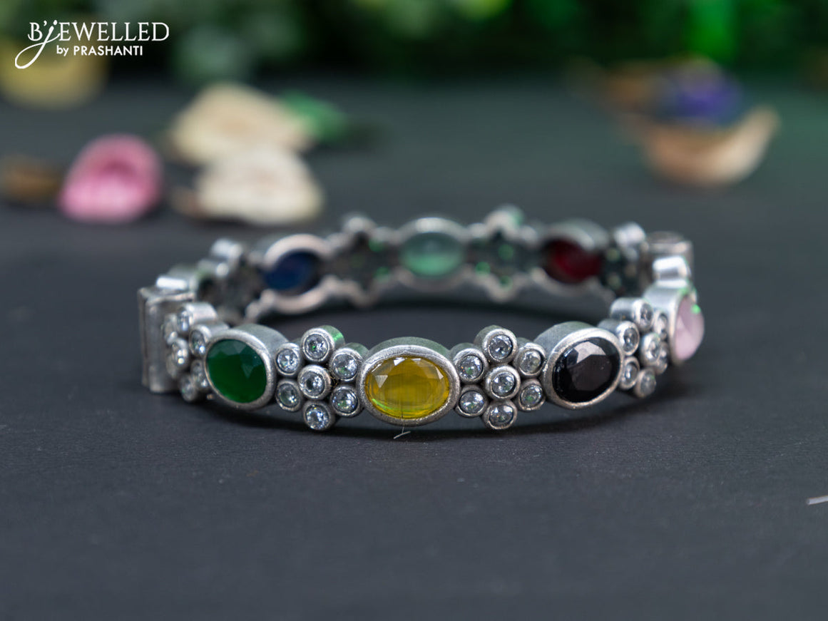 Oxidised floral design screw type bangle with multi colour stones