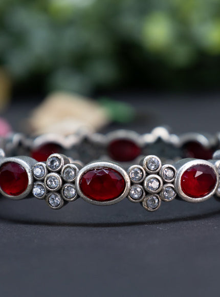 Oxidised floral design screw type bangle with ruby and cz stones