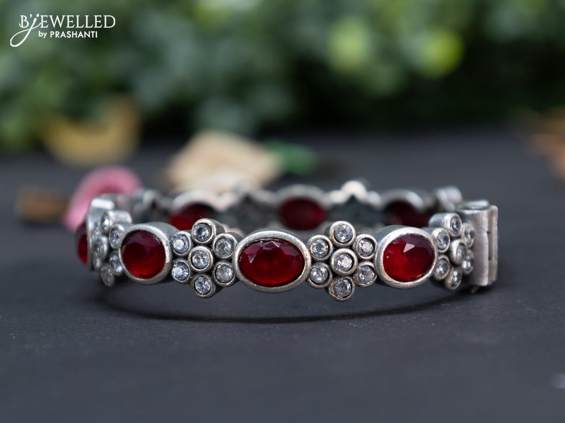 Oxidised floral design screw type bangle with ruby and cz stones