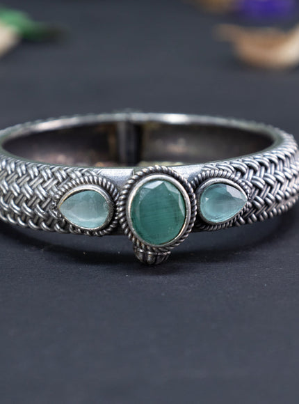 Oxidised screw type bangle with mint green stones