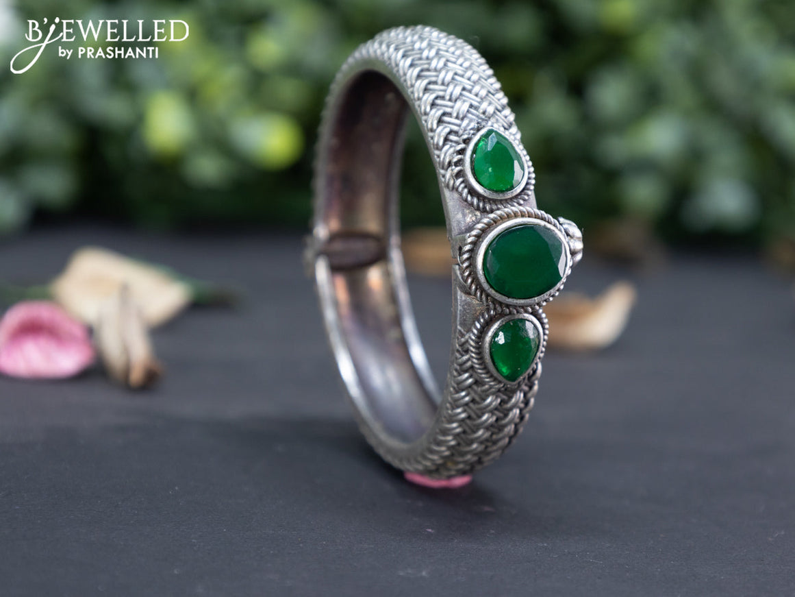 Oxidised screw type bangle with emerald stones