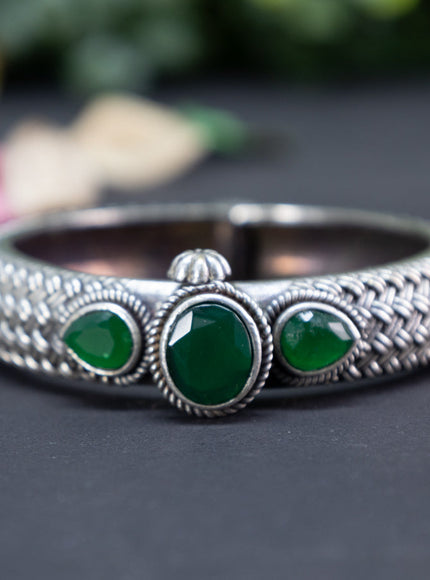 Oxidised screw type bangle with emerald stones