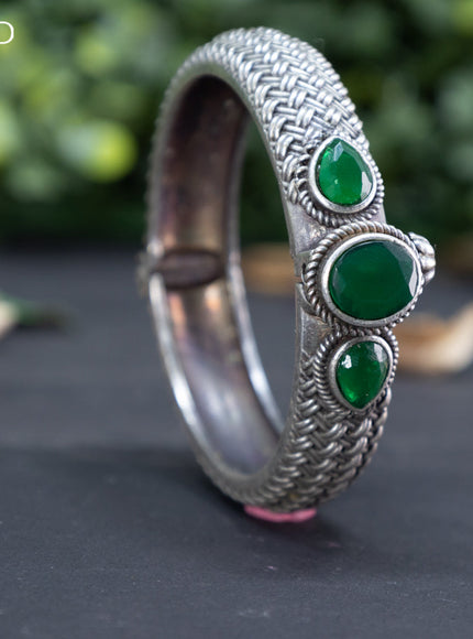 Oxidised screw type bangle with emerald stones