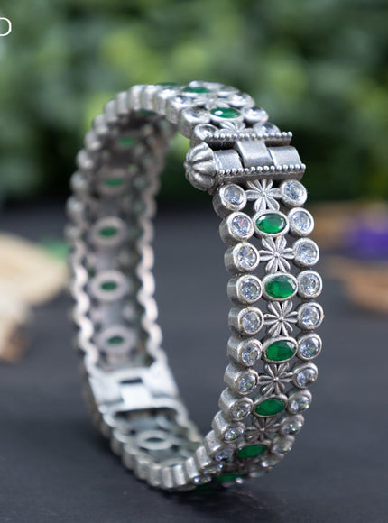 Oxidised screw type bangle with emerald and cz stones