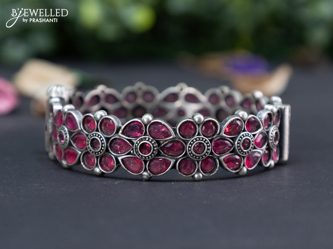 Oxidised floral design screw type bangle with ruby stones