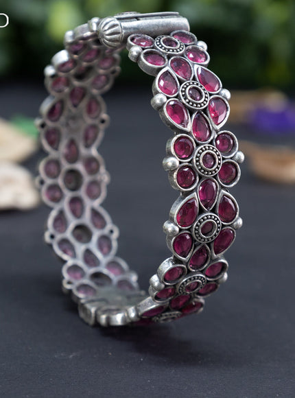 Oxidised floral design screw type bangle with ruby stones